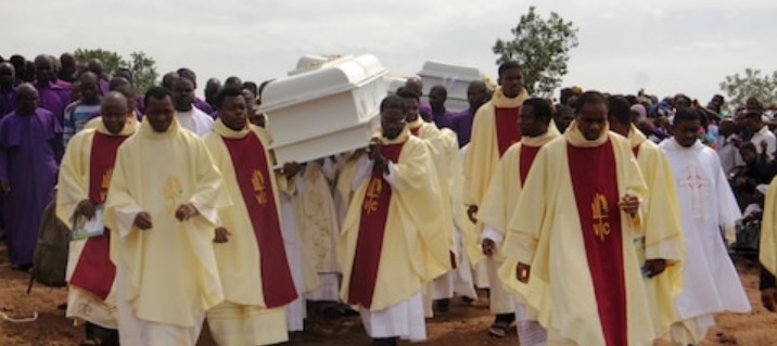 Beerdigung von Christen, die durch islamische Milizen getötet wurden. Priester tragen die Särge von getöteten Priestern.