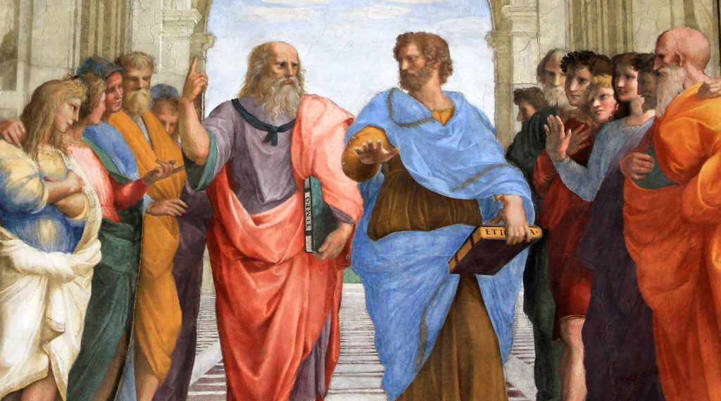 Raffael: Die Schule von Athen.   Platon und Aristoteles (1510)    Das berühmte Gemälde zeigt eine geniale Allegorie:     Platons Zeigefinger deutet die transzendenten Ideen an, und     die Hand des Aristoteles zeigt auf die diesseitige Realität.  